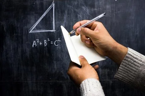 Man taking notes of math theorem on blackboard Stock-Fotos