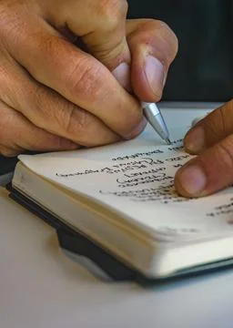 Man taking notes at notebook Stock Photos