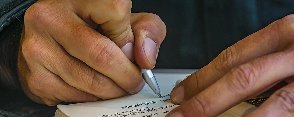 Man taking notes at notebook 스톡 사진