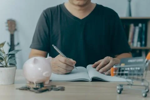 Man taking notes in planning. which is payment online, sits on the chair in.. Stock Photos