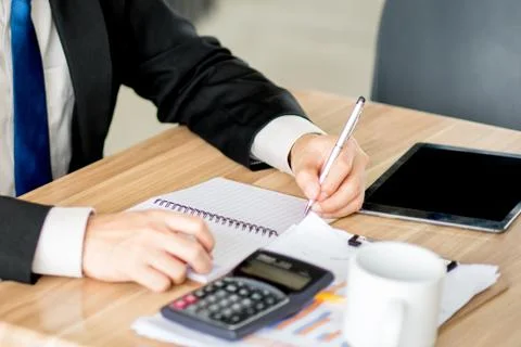 Man taking notes on a small books after business discussion Stock Photos