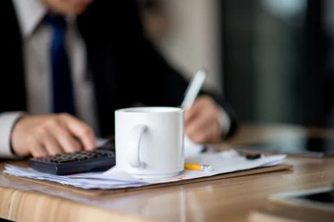 Man taking notes on a small books after business discussion Stock Photos