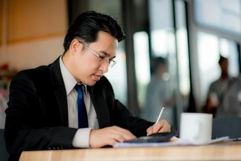 Man taking notes on a small books after business discussion Stock Photos
