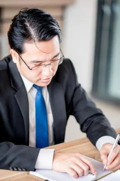 Man taking notes on a small books after business discussion Stock Photos