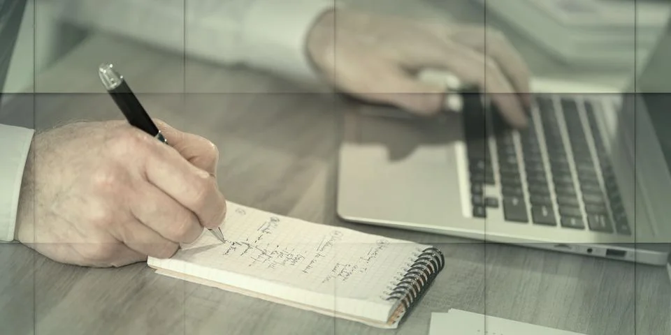 Man taking notes while using laptop, geometric pattern 스톡 사진