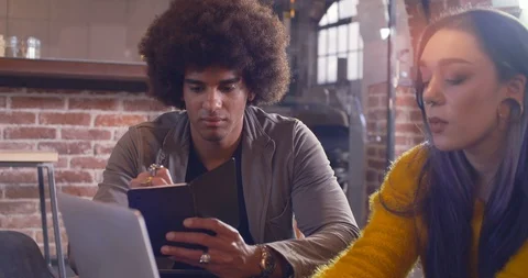 Man taking notes with woman hands in foreground.Group of multiethnic casual Video stock 101251419