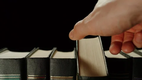 Man Taking One Book From A Row Of The Others Black Books Видео 123555791