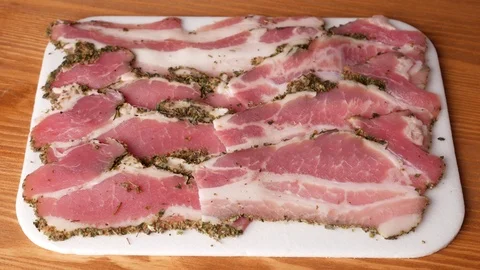 Man taking one slice of bacon. Stock Footage 70877459