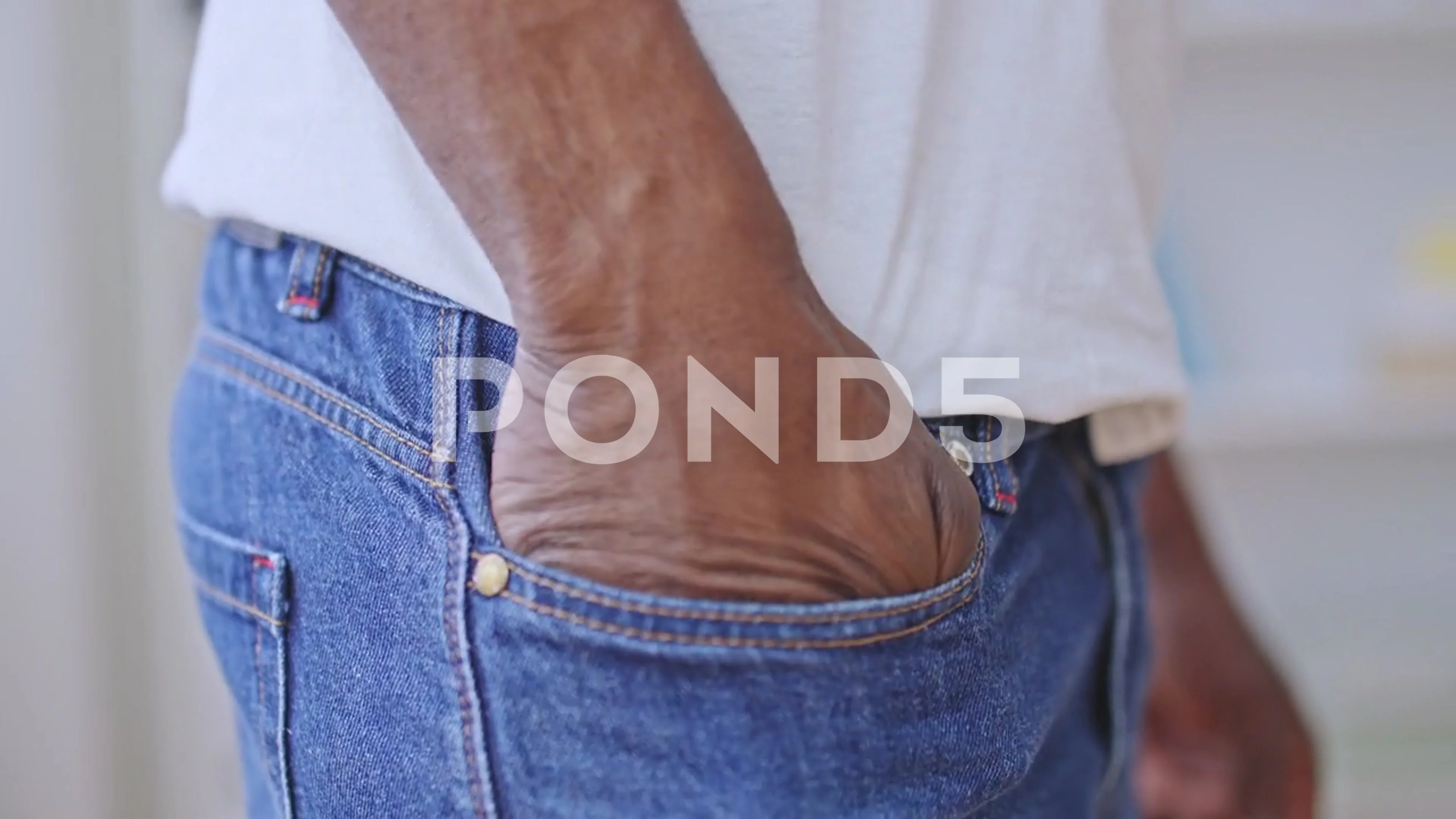 Man taking condom from jeans back pocket Stock Photo