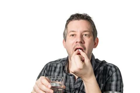 A man Taking painkiller Stock Photos