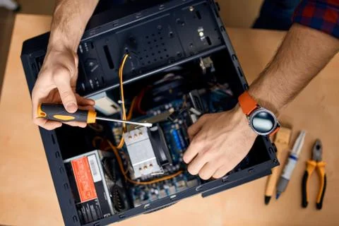 Man taking off part of desktop system unit Stock Photos