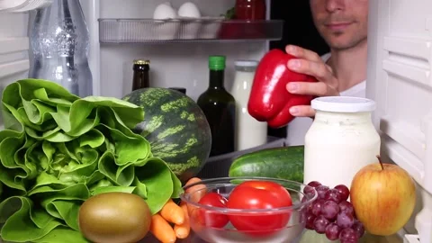 Man taking a pepper out of a fridge Video stock 135381544