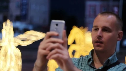Man taking photo with camera phone at night. Young casual man taking picture Video stock 76639350