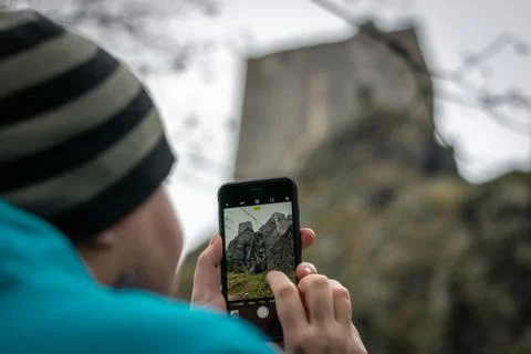 Man taking photo of a castle on his smartphone Stock Photos