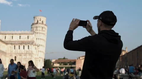 Man taking photo with cellphone by Leaning Tower of Pisa Stock Footage 98564776