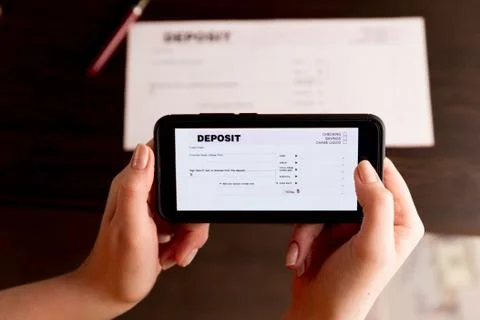 Man Taking Photo Of Cheque To Make Remote Deposit In bank. Stock Photos