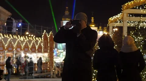 Man is Taking Photo Christmas Fair Sophia Square Kiev New Year's Evening on a 動画素材 59131772