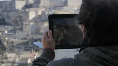 Man taking a photo with her tablet pc camera while traveling Stock Footage 34278704