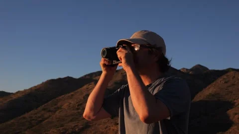 A man taking a photo at a scenic viewpoint Stock Footage 335163653