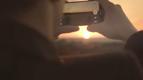 Man taking a photo of the sun Stock Footage 72555829