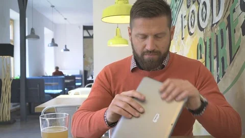 Man taking photo by tablet computer, portrait, in cafe, indoor, steadicam Vídeo Stock 73230446
