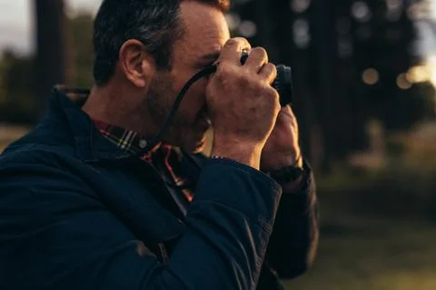 Man taking photo using a camera Stock Photos
