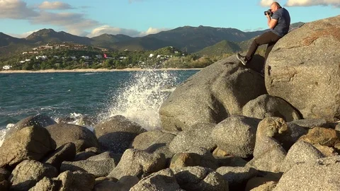 Man taking a photos with dslr camera outdoors, on the beach Stock Footage 120729049