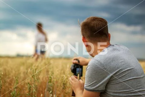 Man taking photos of his girlfriend outdoor. couple leisure and pastime Stock Photos
