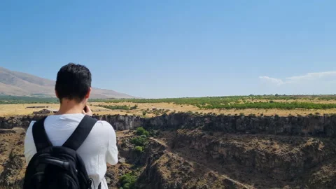 A man taking photos of a panoramic view with his smartphone Video stock 206089736