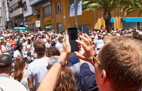 Man taking photos of the procession using mobile phone. Stock Photos