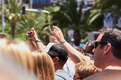 Man taking photos of the procession using mobile phone. Stock Photos