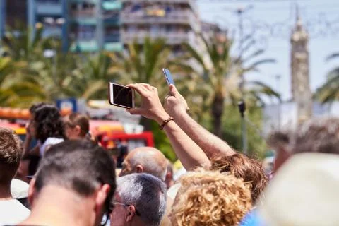 Man taking photos of the procession using mobile phone. Stock Photos