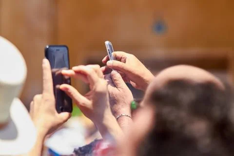 Man taking photos of the procession using mobile phone. Stock Photos