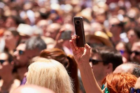Man taking photos of the procession using mobile phone. Stock Photos