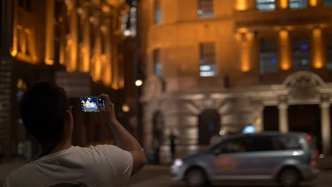 Man is Taking a Picture with Cell phone on Shanghai Bund at Nighttime, 4k Stock Footage 121195341