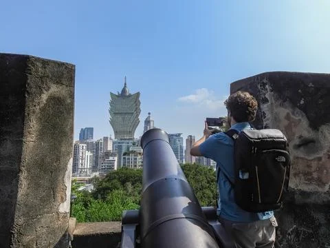 Man taking picture with cell phone of the cassino Lisboa, Stock Photos