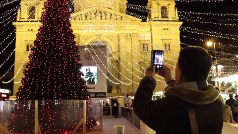Man taking picture of Christmas tree Stock Footage 83680133