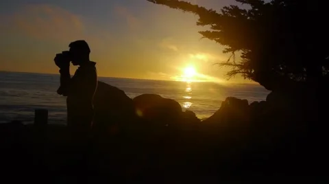 Man Taking Pictures In Front Of Sunset Stock Footage 46559793