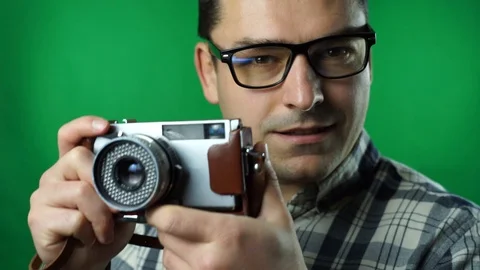 Man taking pictures with an old camera. green screen background Video stock 87176311