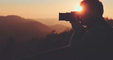 Man Taking Pictures of Sunlit Fall Mountain Landscape. SLOW MOTION. Vídeo Stock 140321907