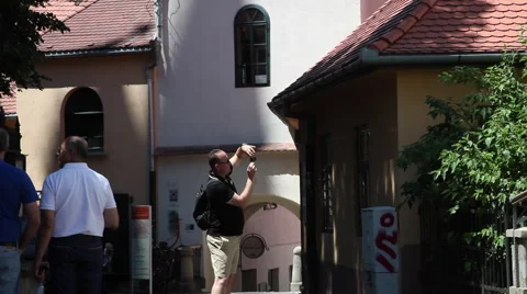 Man taking pictures, vacation, old European town, tourists, summer Stock Footage 40558309