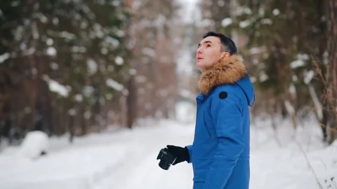 Man taking pictures in winter forest Stock Footage 102775734