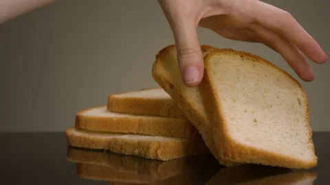 Man taking piece of bread. Stock footage. Close-up of man taking fresh slice of Stock Footage 145076319