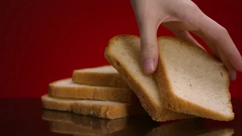 Man taking piece of bread. Stock footage. Close-up of man taking fresh slice of Stock Footage 145076401