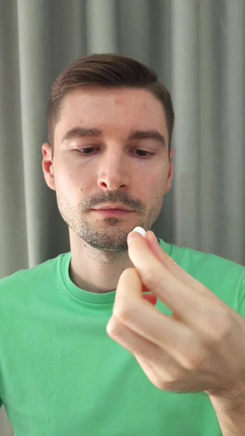 Man taking a pill and drinking water from a glass. Health and medication concept Stock Footage 284042803