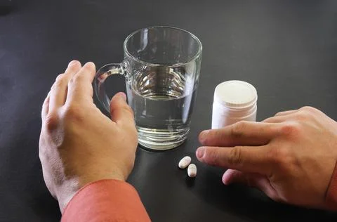 The man is taking pills Stock Photos