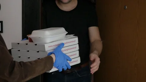 Man taking pizza boxes from food delivery courier wearing gloves protective mask Vídeo Stock 127628757
