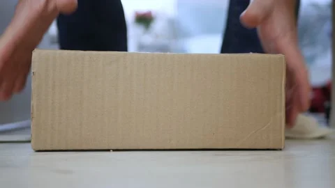 Man Taking a Postal Package from the Door, Delivered by a Postal Courier. Stock Footage 166744488