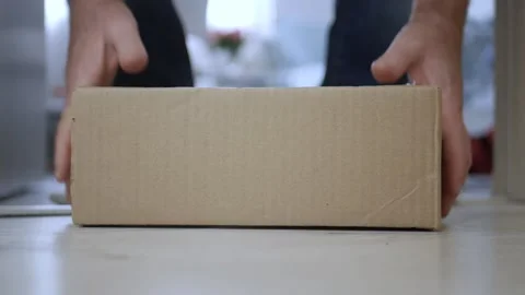 Man Taking a Postal Package from the Front of the Door Delivered by Courier. Stock-Footage 168405665
