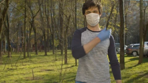 Man taking off protective mask and gloves Stock Footage 130969689